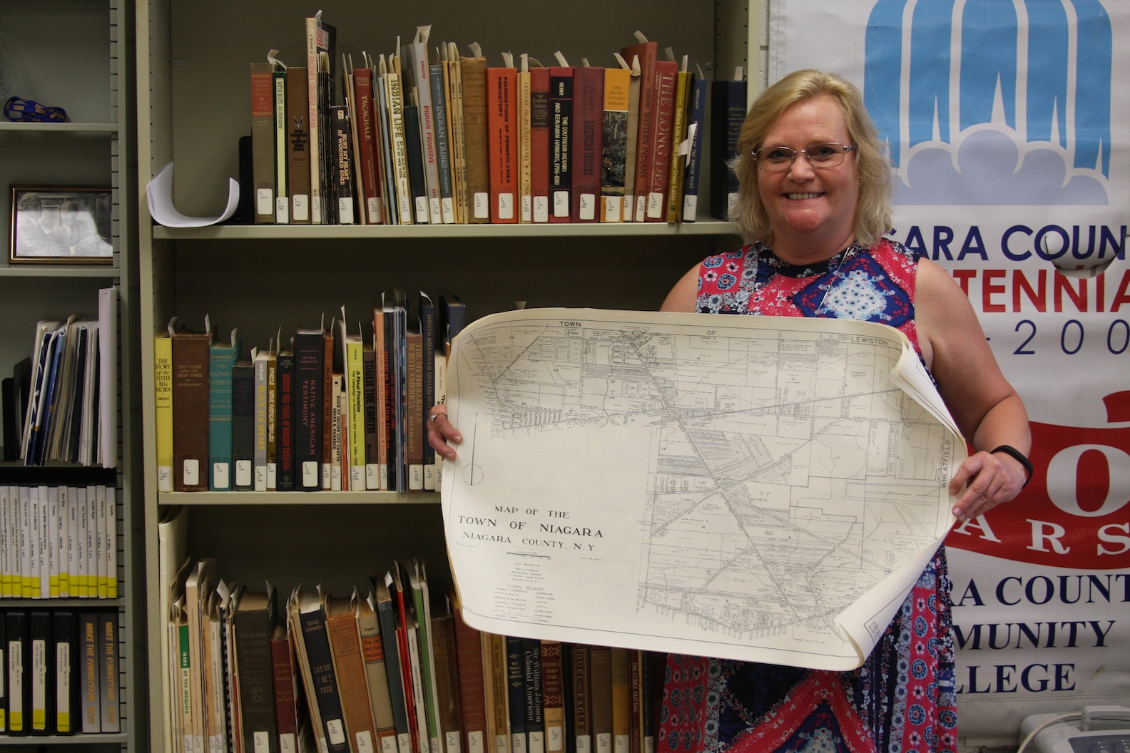 NCCC Library employee, Barbara Rupple pictured with a map of the Town of Niagara.